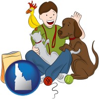 idaho map icon and a young man pet sitting a cat, a dog, and a bird