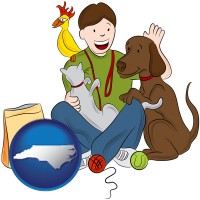 north-carolina map icon and a young man pet sitting a cat, a dog, and a bird